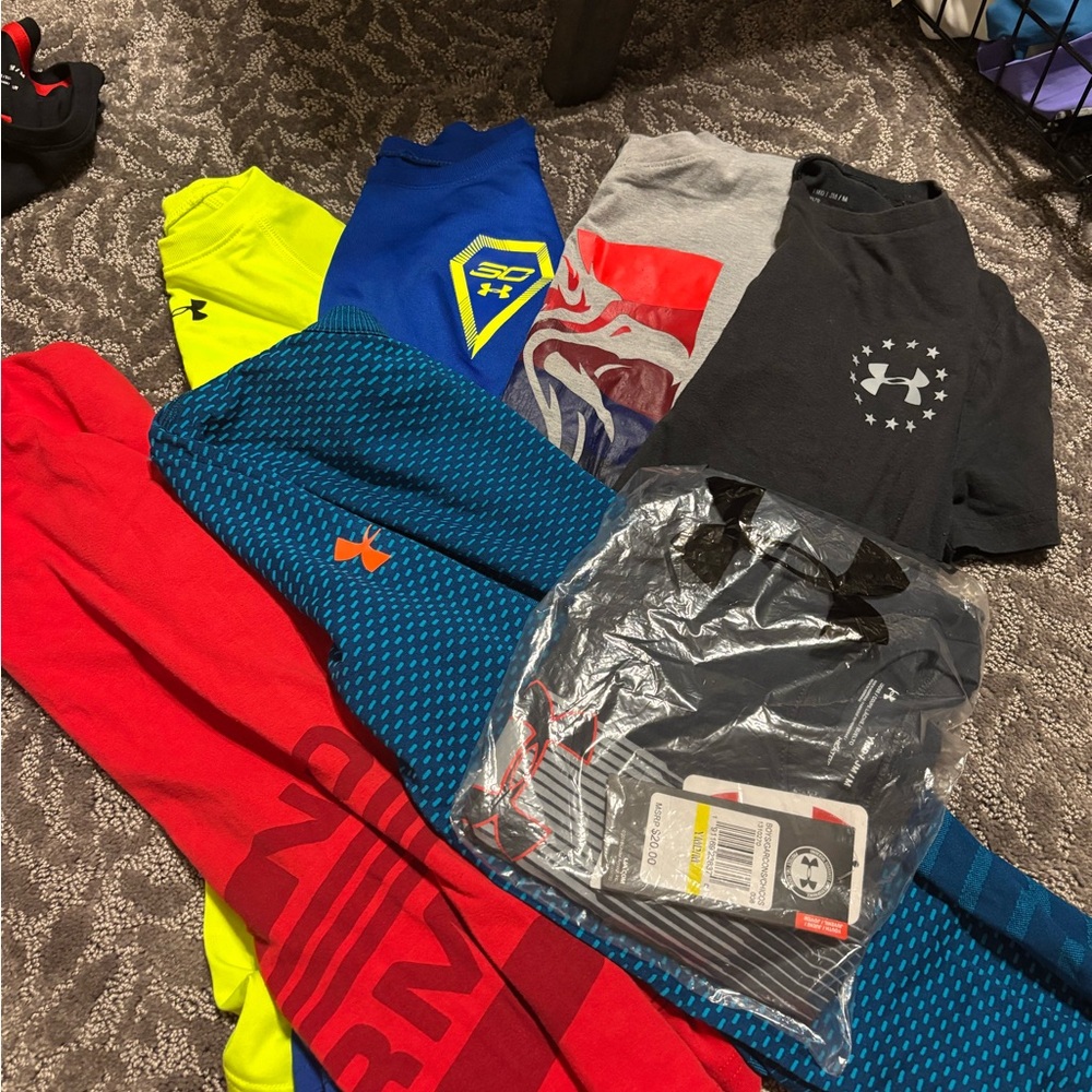 6 short sleeve Under Armour Short Sleeve Tees and 1 UA long sleeve shirt